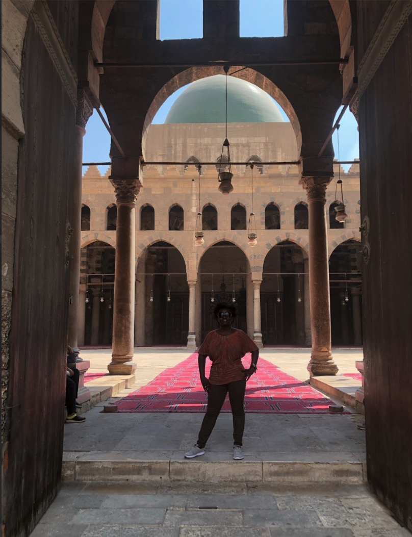 Sacred courtyard of an ancient Cairo mosque with green dome