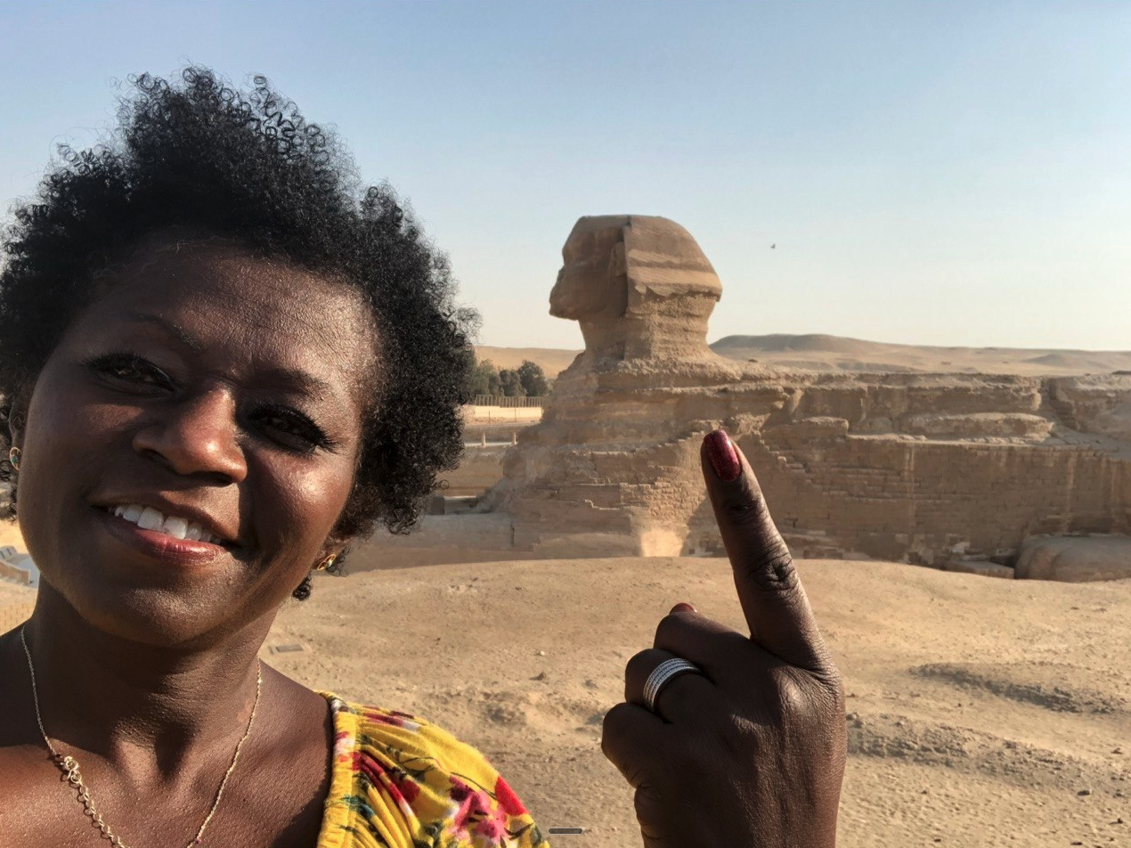 Pilgrim standing in the presence of the Great Sphinx of Giza