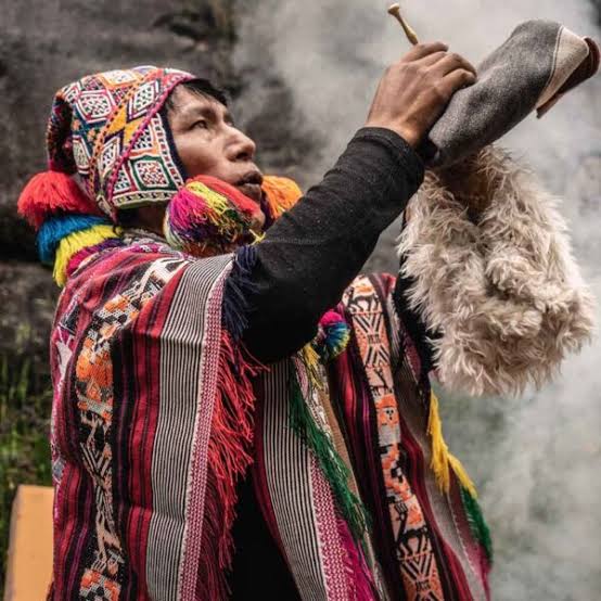 Andean lineage carrier in ceremonial offering by the waterfall