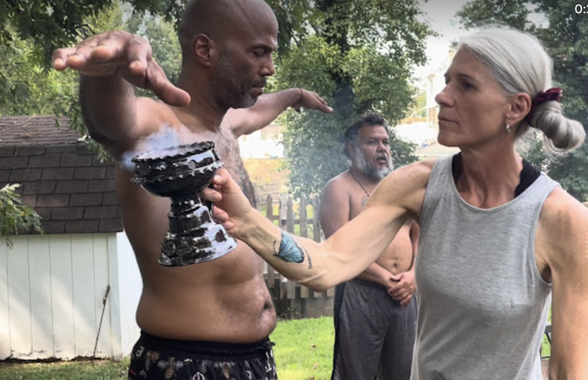 King James in outdoor sacred ceremony with community support at Temple Mother Earth