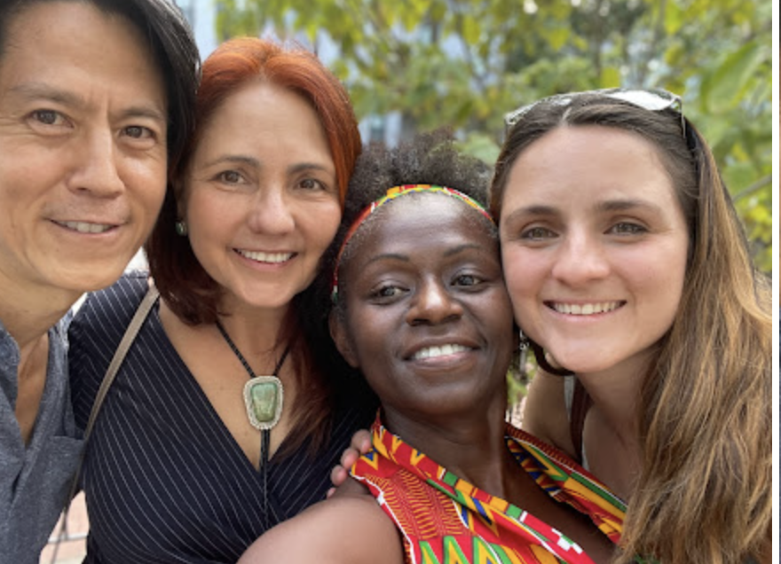 Temple Mother Earth smiling community members in close group portrait